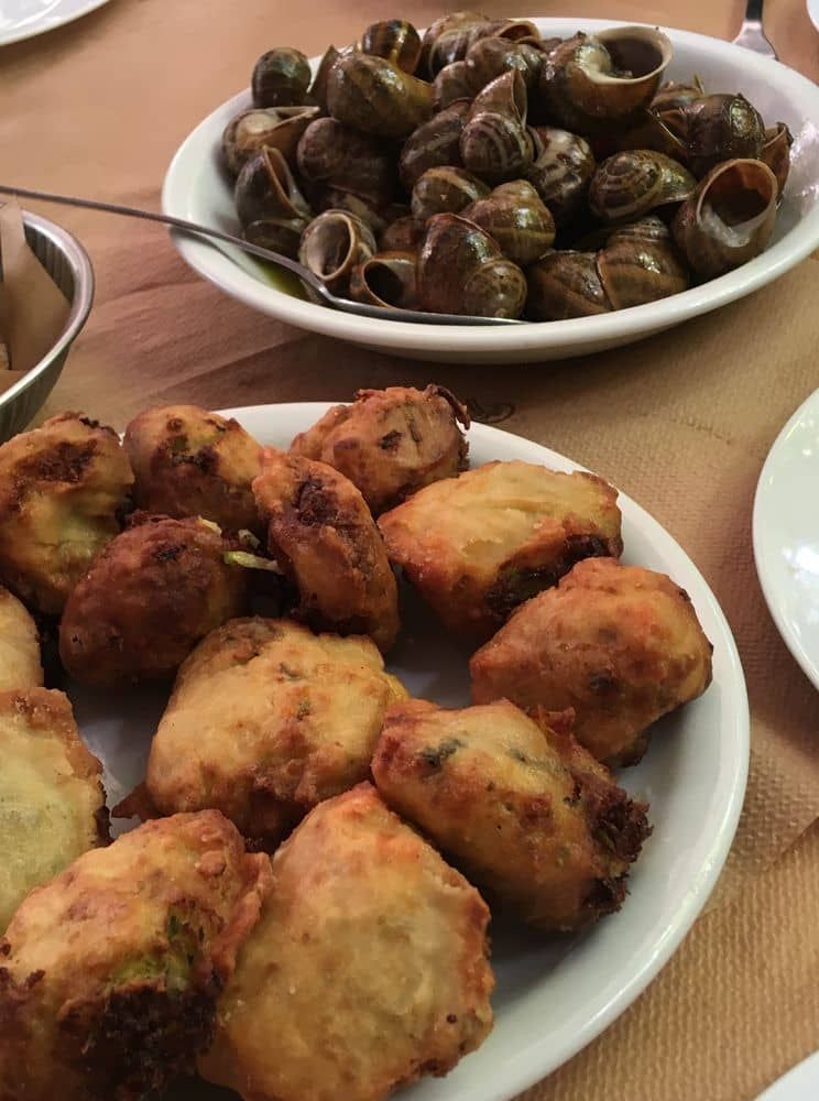 Kolokythokeftedes (zucchini fritters) and snails with rosemary, a specialty of Crete