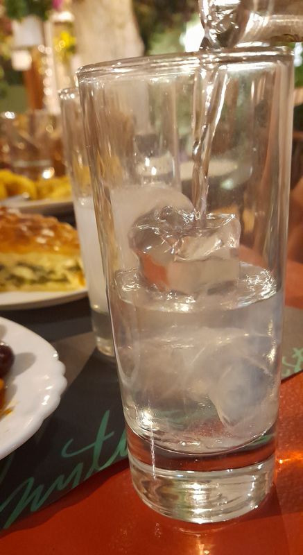 ouzo poured over ice cubes